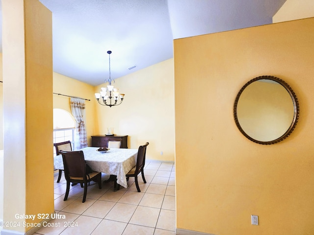 dining area featuring light tile patterned floors and a chandelier