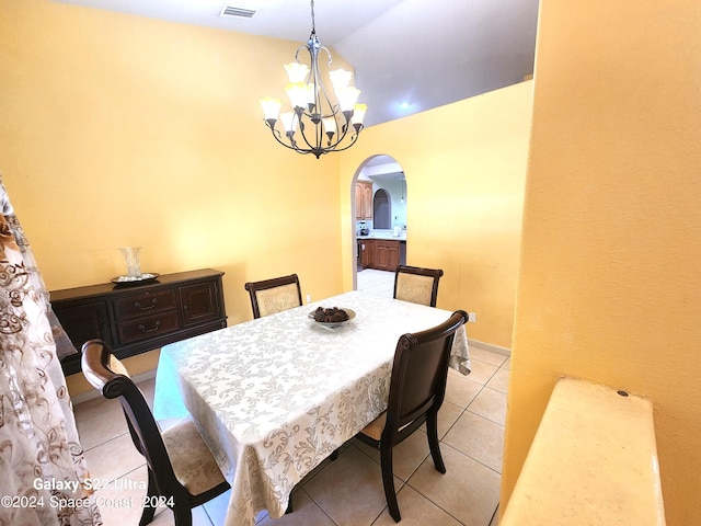 dining space with an inviting chandelier and light tile patterned floors