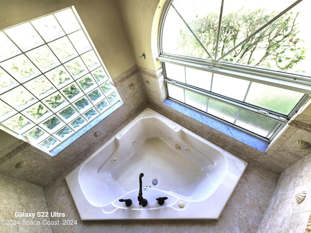 bathroom featuring a relaxing tiled tub