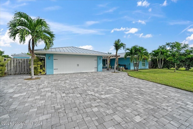 ranch-style home with a garage and a front yard