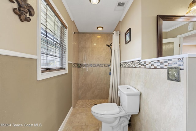 bathroom featuring crown molding, toilet, tile patterned flooring, and walk in shower