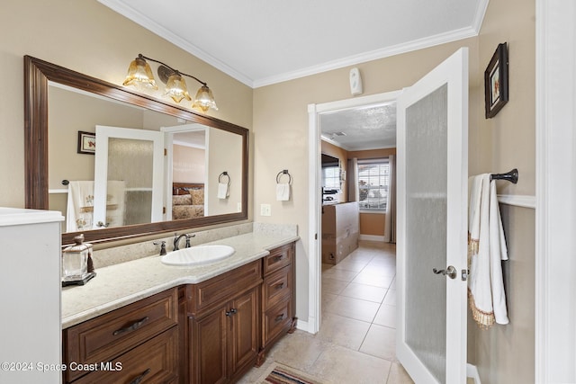 bathroom with ornamental molding, tile patterned floors, and vanity