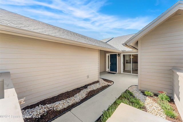 618 Mimosa Ct, Melbourne, FL 32940 - view of exterior entry featuring roof with shingles