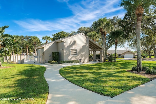 618 Mimosa Ct, Melbourne, FL 32940 - view of home's exterior featuring fence, a yard, and a gate