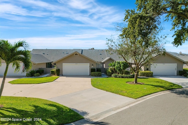 ranch-style house with a garage and a front lawn