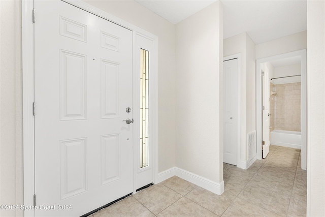 foyer entrance with light tile patterned flooring