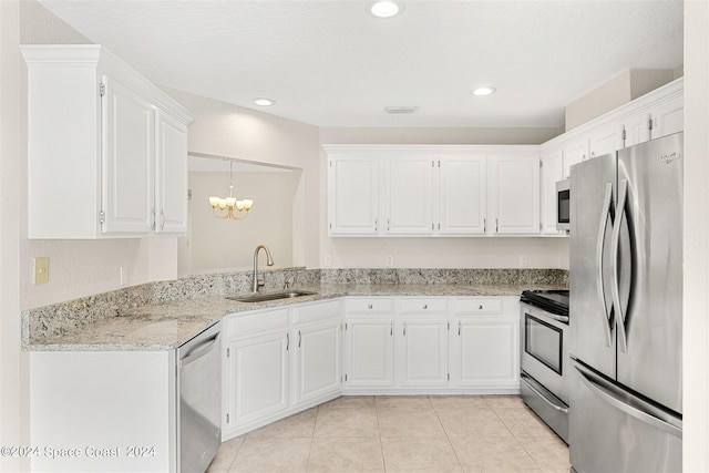 kitchen with light stone countertops, appliances with stainless steel finishes, sink, and white cabinets