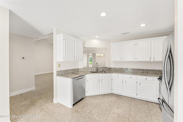 kitchen featuring sink, white cabinetry, light stone countertops, light tile patterned flooring, and stainless steel dishwasher