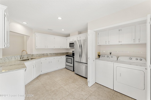 618 Mimosa Ct, Melbourne, FL 32940 - laundry area with a sink, light tile patterned floors, washing machine and clothes dryer, and recessed lighting