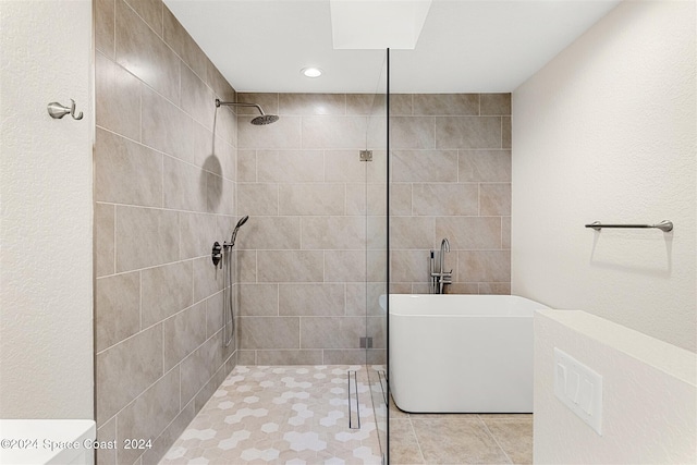 bathroom featuring shower with separate bathtub and tile patterned floors