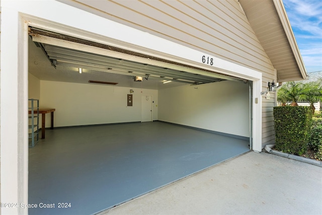 garage featuring a garage door opener and electric panel