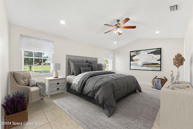 tiled bedroom featuring multiple windows, vaulted ceiling, and ceiling fan