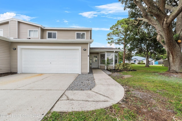 view of front of home with a garage and a front yard