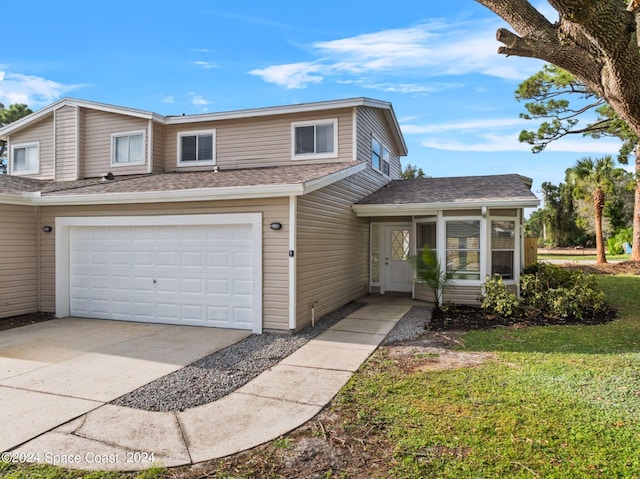 view of front property with a front yard and a garage