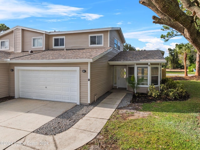 front facade with a garage and a front yard