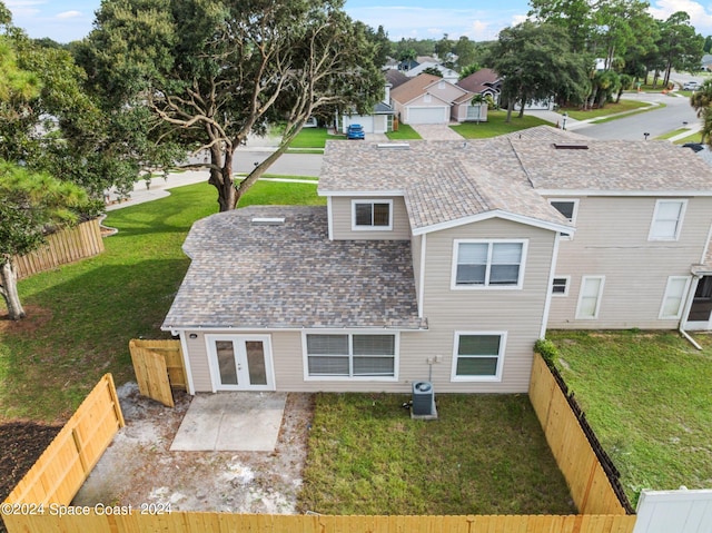 back of house with french doors, a lawn, a patio, and central AC unit