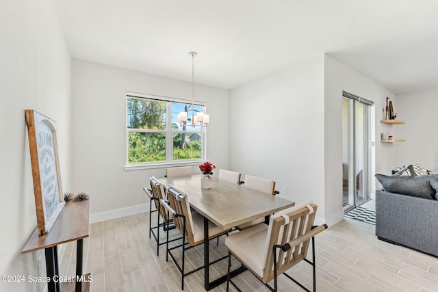 dining room featuring an inviting chandelier and light wood-type flooring