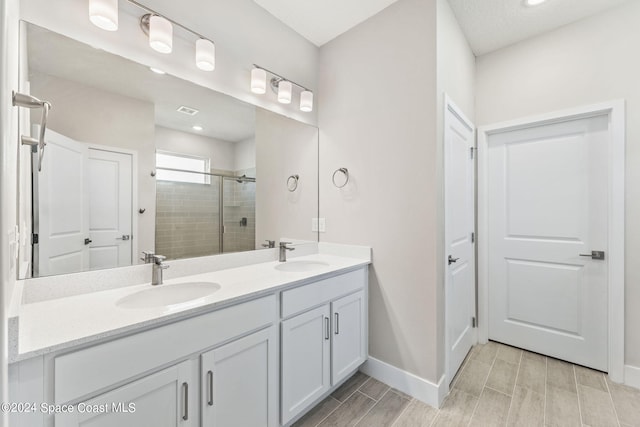 bathroom with vanity and an enclosed shower