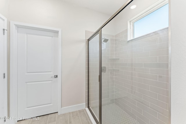 bathroom featuring a shower with shower door