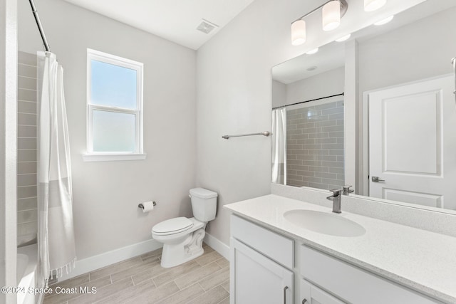 full bathroom featuring shower / bath combo with shower curtain, vanity, and toilet