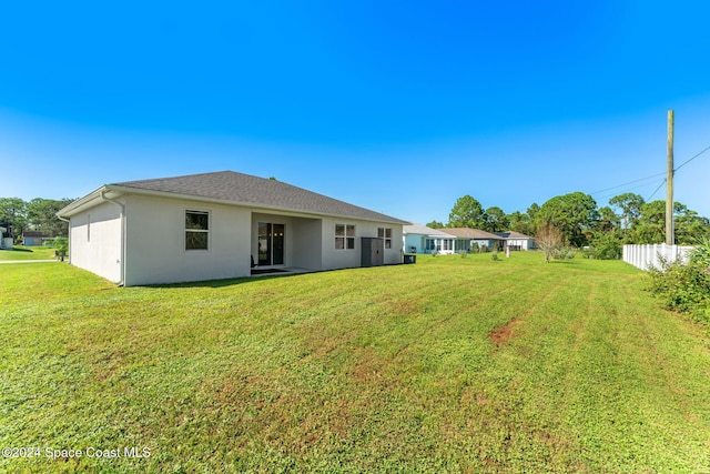 back of property featuring a yard