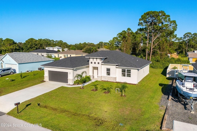 view of front of home with a garage and a front yard