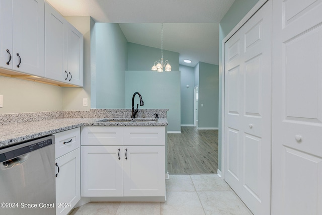 kitchen featuring stainless steel dishwasher, white cabinetry, sink, and a chandelier