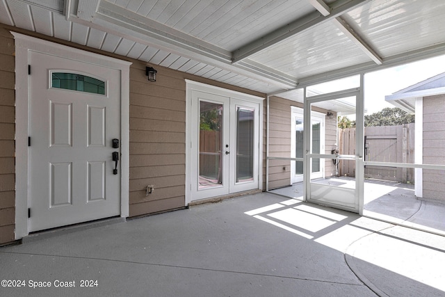 unfurnished sunroom with french doors and a wealth of natural light