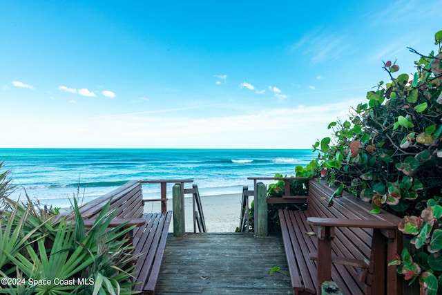 exterior space featuring a water view and a view of the beach