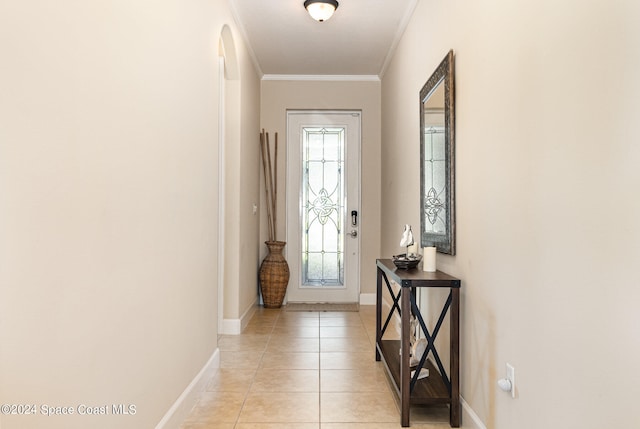 entryway featuring light tile patterned floors and ornamental molding