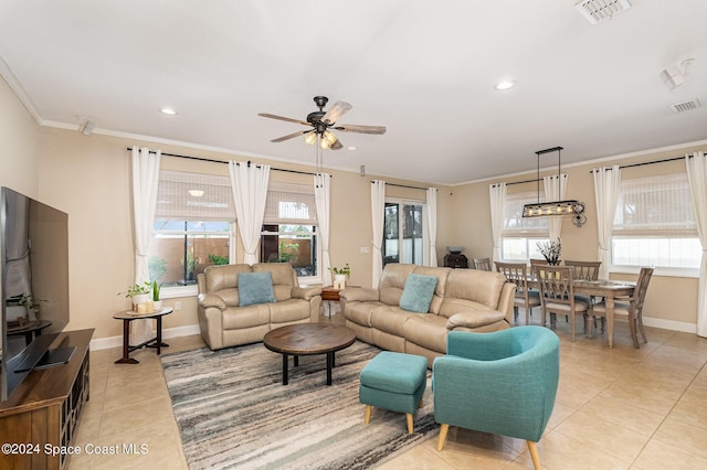 694 Mission Bay Dr, Satellite Beach, FL 32937 - living area with light tile patterned floors, a ceiling fan, ornamental molding, plenty of natural light, and baseboards