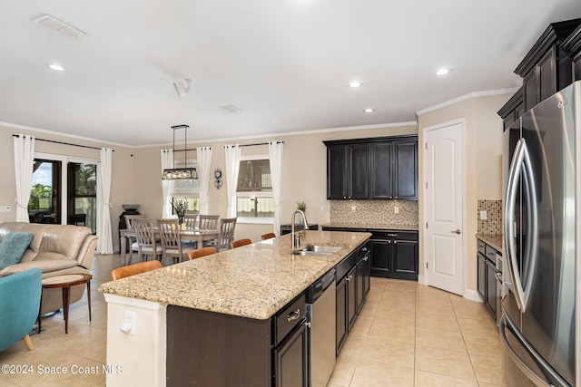 694 Mission Bay Dr, Satellite Beach, FL 32937 - kitchen featuring appliances with stainless steel finishes, a sink, light tile patterned floors, backsplash, and open floor plan