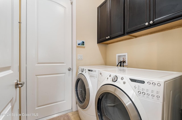 694 Mission Bay Dr, Satellite Beach, FL 32937 - laundry room with washer and clothes dryer, cabinet space, and light tile patterned flooring