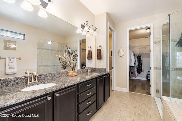 bathroom with tile patterned flooring, vanity, and an enclosed shower