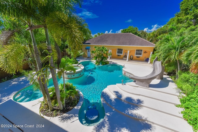 view of pool featuring a patio and a water slide