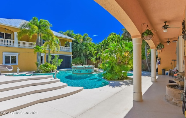 view of swimming pool featuring ceiling fan, an in ground hot tub, and a patio area