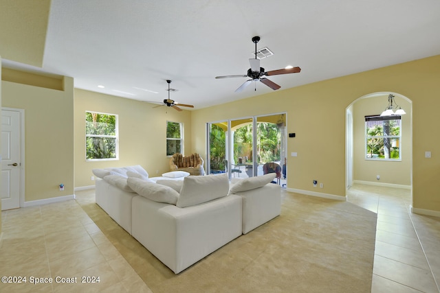 living room with a healthy amount of sunlight, light tile patterned flooring, and ceiling fan