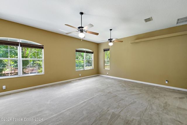 carpeted empty room featuring ceiling fan