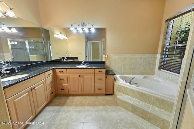 bathroom featuring vanity, shower with separate bathtub, and tile patterned floors