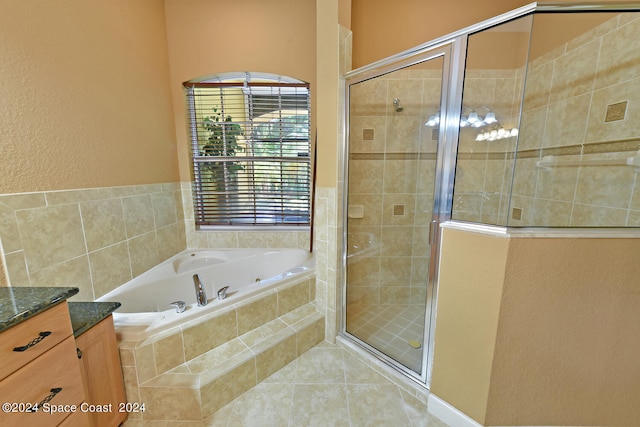 bathroom featuring independent shower and bath, vanity, and tile patterned floors