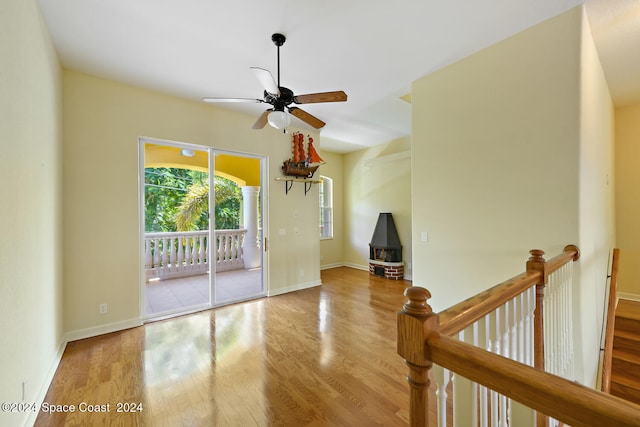 empty room featuring wood-type flooring and ceiling fan