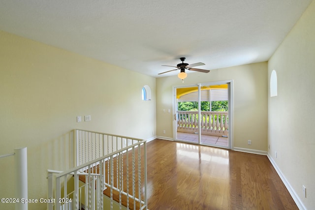 spare room featuring ceiling fan and hardwood / wood-style flooring