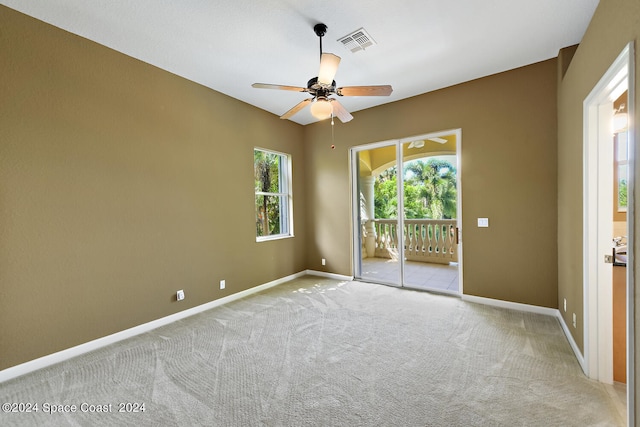 carpeted spare room with ceiling fan