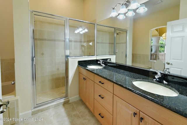 bathroom featuring plus walk in shower, tile patterned floors, and vanity