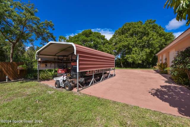 view of parking with a yard and a carport