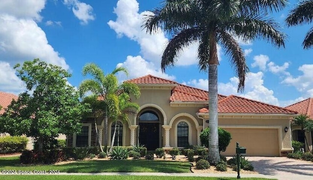 mediterranean / spanish house featuring a garage