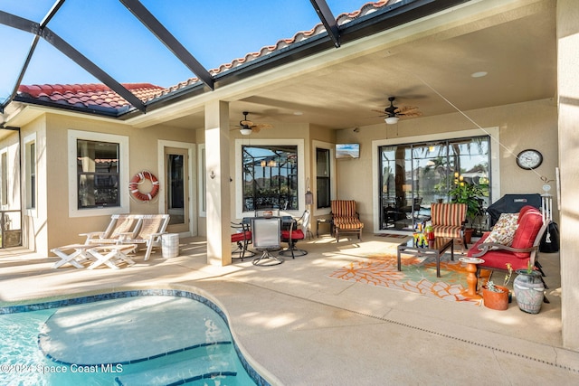 view of pool with a patio, ceiling fan, and a lanai