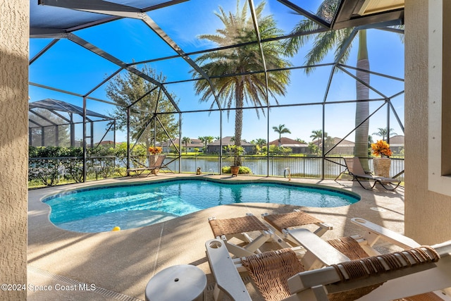 view of swimming pool featuring a patio, a lanai, and a water view