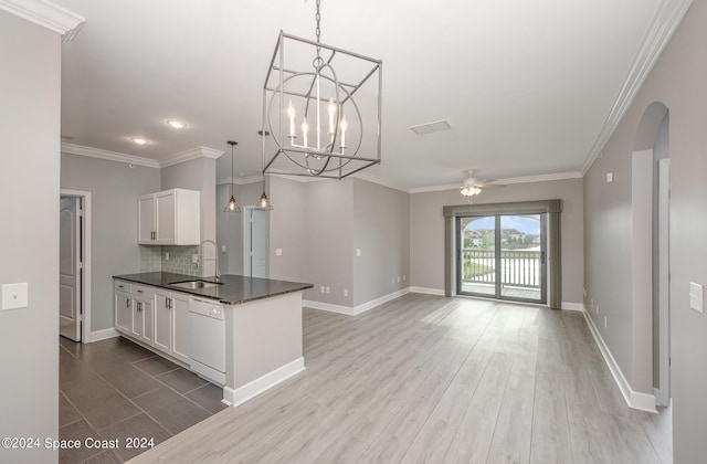 kitchen with white cabinets, white dishwasher, sink, decorative light fixtures, and hardwood / wood-style floors