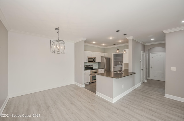 kitchen featuring pendant lighting, white cabinetry, kitchen peninsula, light hardwood / wood-style flooring, and appliances with stainless steel finishes